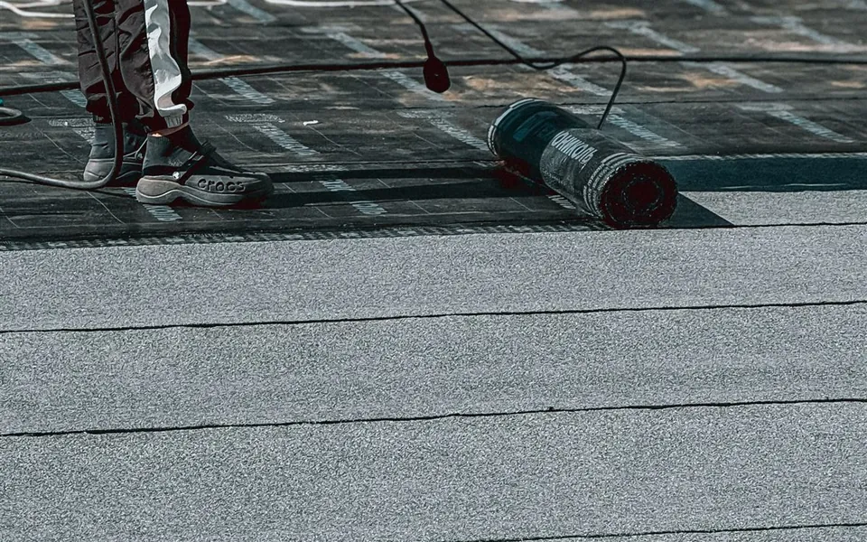 Rolled membrane and seam detail across a finished flat roof surface