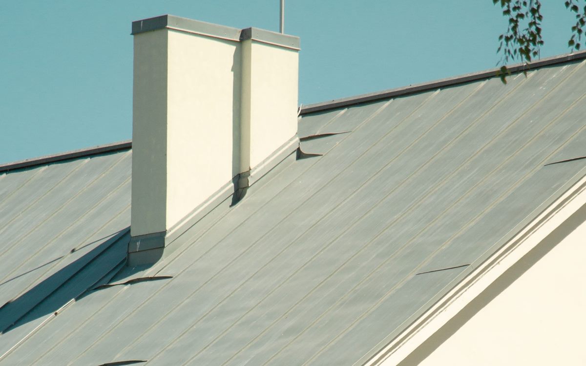 Standing seam metal roof panels running up to the ridge line