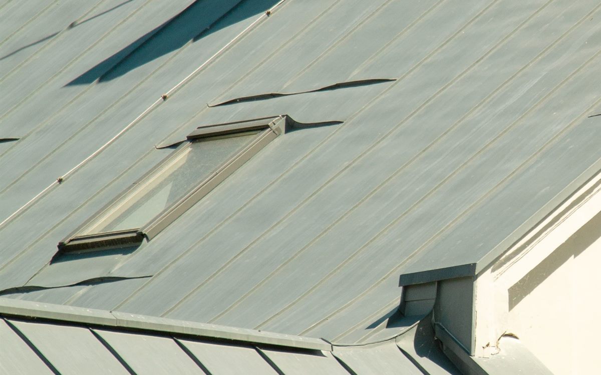Skylight set into a standing seam metal roof with flashing around the frame