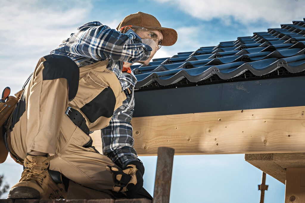 Roofing contractor inspecting new blue tile installation on sunny day.